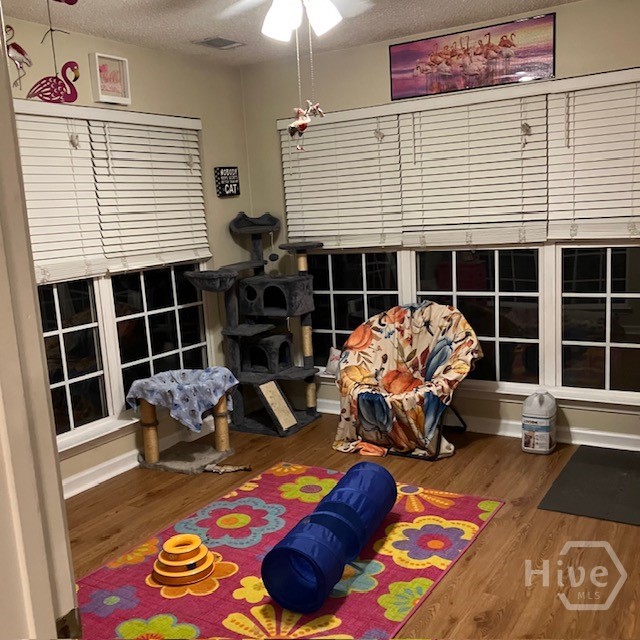 Sunroom with ceiling fan and blinds