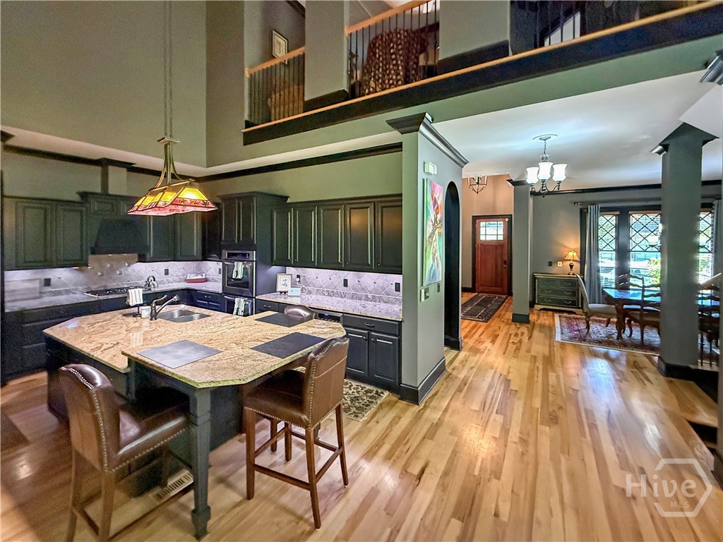 Custom Cabinets with under lighting that accents the tile backsplash and granite counter tops