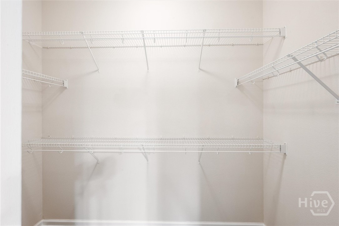 Walk-in closet with built-in shelving.