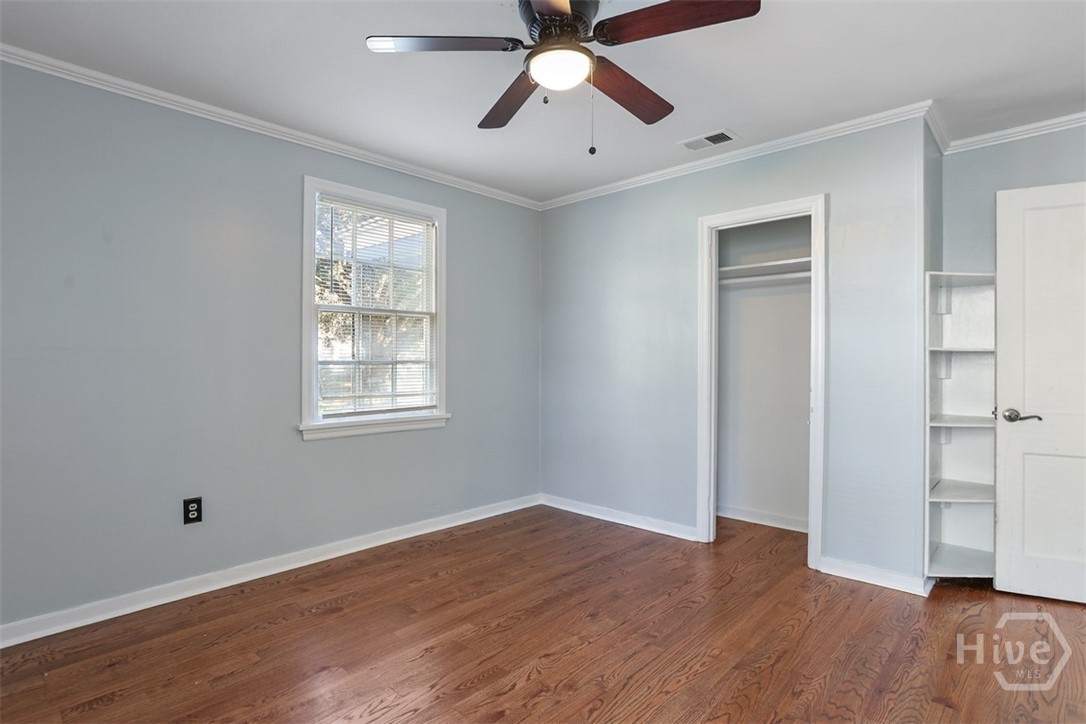 Lighted ceiling fan and hardwood floors.