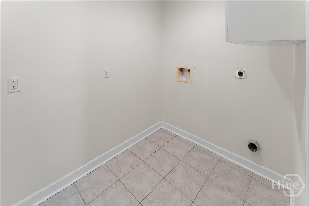 Spacious laundry room with cabinets