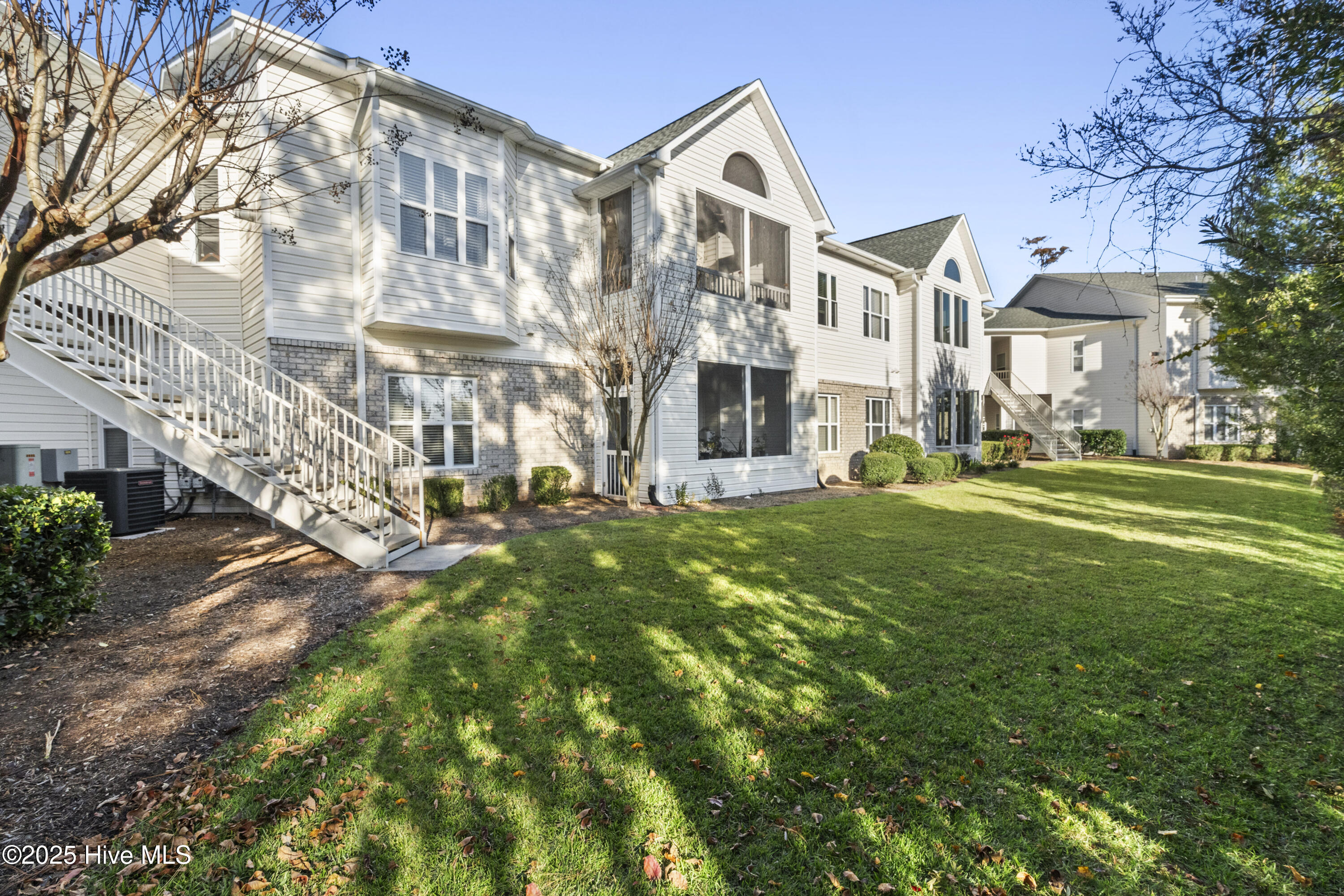 Proudly maintained, open but cozy 2nd floor condo would be easy to call home and includes a top-tier 1-year home warranty. Quiet neighborhood amongst mature trees, ponds and lawn that you didn't have to mow. The great room with entry area offers expansive height and natural light while sturdy wood floors, gas fireplace and bay window invite you to settle in. Half wall between living/ dining was removed for flow. Dining area with glass slider opens to screened/ covered porch, perfect for quiet times or gathering. Wood cabinets and counter bar are nice touches to an ample kitchen. Kitchen appliances plus washer and dryer included in sale. Laundry/ utility room offers extra storage space. Primary bedroom is spacious and restful, with a generous walk-in closet. Primary Bath features whirlpool, walk-in shower and separate wash closet. Second bedroom (or office) has a walk-in closet and great natural light. Adjacent bath is gracious and has tub/shower combo for versatility and a small storage closet. Coat closet in hall. Gas hot water heater, efficient heating system plus A/C. Exterior storage closet on landing. Community pool for summer days. Low maintenance living close to Riverlights convenient to shopping, the Hospital and beaches.