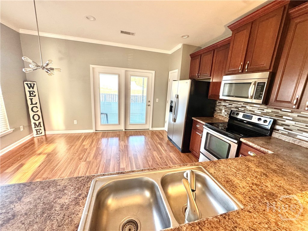 Kitchen with Glass Doors Leading to Screened in Sun Porch and Lagoon Views!