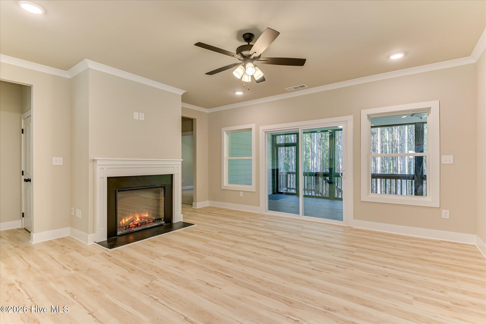 Electric fireplace with sliding doors to rear screened porch