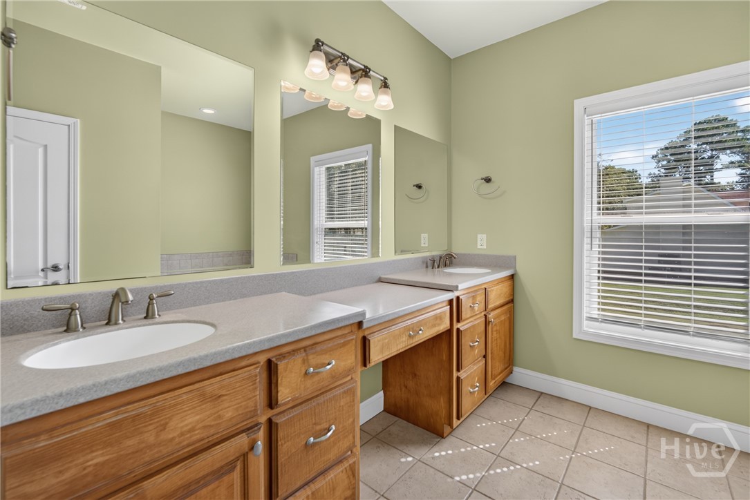 Master bathroom featuring two vanities.
