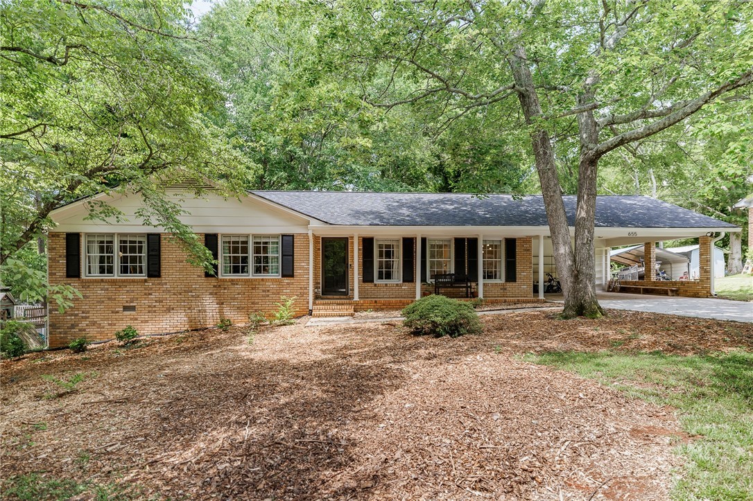 Well maintained, one level, all brick ranch located in one of Athens' best kept secrets... University Heights! New architectural shingle roof installed July 2025! Upon entry, the living and dining rooms are spacious and warm. Original hardwood flooring runs throughout a majority of the home including all bedrooms. A cozy den with masonry, wood-burning fireplace leads to a sun room that overlooks the fenced backyard. Plenty of cabinet storage and counter space in the kitchen and laundry room. Newer LVP floors run through the den, kitchen, and laundry areas. Primary suite features an updated ensuite bathroom while two additional bedrooms share a spacious hall bath with vintage 1960s tile. This one is all buttoned up and ready for its new owner! Come home to University Heights and 655 University Circle - enjoy a quiet, low traffic neighborhood, access to walking trails along the North Oconee River, scoot over to Five Points in five minutes, or enjoy the amenities of the Eastside like the new Kroger and an array of restaurants. The UGA Veterinary Teaching Hospital is adjacent to University Heights as well. You can't find a better location for this price!