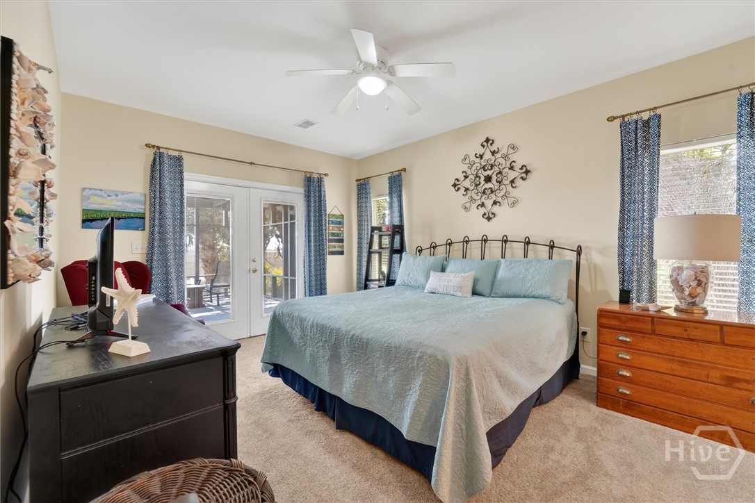 Primary suite with sliding glass doors to the screened porch