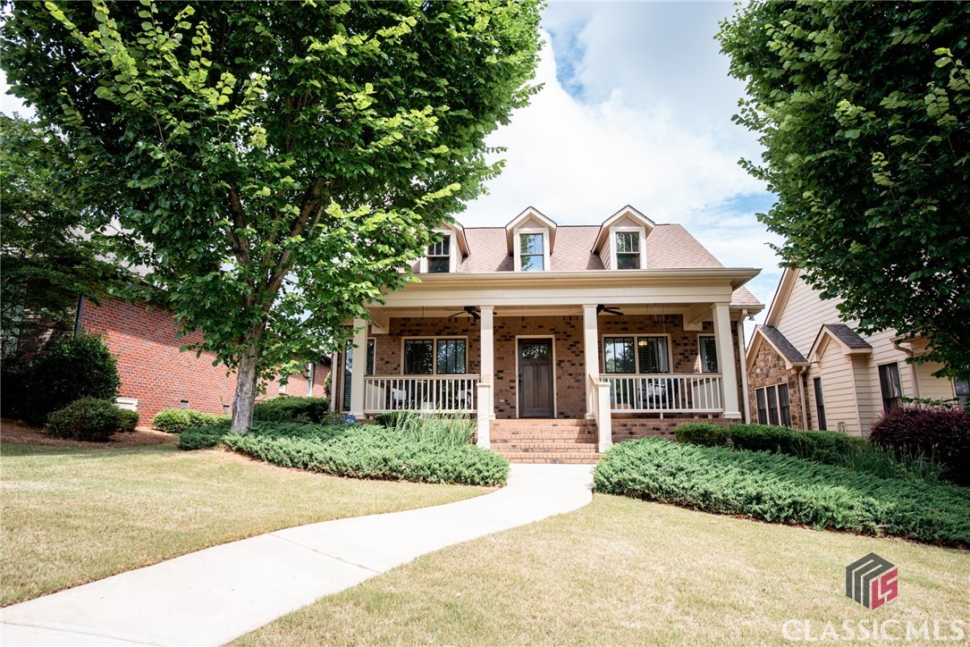 Situated in the popular swim/tennis community of Meadow Springs in Oconee County, this custom-built home boasts a coveted ranch floor plan, elegant finishes, and a convenient, desirable location. Enjoy site-finished hardwood floors throughout the living area and kitchen and 9ft ceilings throughout the home. The living room balances light, open and airy with comfort and coziness as it boasts large windows, a beautiful stained bead-board tray ceiling, a gas-log fireplace with custom mantelpiece and elegant crown molding and trim.  Open to the living room, the kitchen features granite countertops, lots of cabinet storage, and a large eat-in dining area.  A convenient and practical mudroom area and custom bench sits at the backdoor, and a well appointed built-in office space sits off the hallway. The laundry room provides additional functionality with a utility sink and additional cabinet storage.  The private master suite is sizable and features a walk-in tiled shower, garden tub, double vanity with granite countertops and two walk-in closets.  The two additional bedrooms are nicely sized and share a centrally located bathroom with a tile-surround tub/shower. The outside offers versatile space for relaxation or entertaining.  A covered front porch provides the perfect setting for rocking chairs, porch swings, and hanging baskets, and the patio on the backside provides the perfect casual grilling or dining space. The fenced-in yard is an ideal space for a small dog, garden beds or play area and is accessible to the the rear-entry two car garage.  Attic storage is available above the garage.   Located in a friendly and bustling pool and tennis community, this home is in move-in ready condition and waiting for someone to make it their home. Zoned for award-winning Oconee County Schools and less than two miles from the schools.  This home sits just minutes to Butlers Crossing in one direction and Epps Bridge Parkway in the other, providing easy access to shopping, dining, and entertainment in Oconee County or Athens.