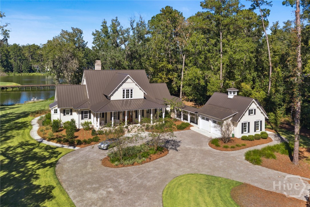 Where Lowcountry beauty meets timeless design, this custom-built estate at The Ford Field & River Club tells a story of Southern grace and quiet luxury. Set on 5.5 private acres with serene water and golf course views, the home welcomes you with wide porches, grand oaks, and peaceful natural surroundings. Inside, every detail reflects comfort and craftsmanship—from the gourmet kitchen and formal dining area to two cozy fireplaces perfect for Lowcountry evenings. The main house offers three bedrooms, including a serene primary suite with dual walk-in closets and a spa-like bath. Just beyond, a beautifully appointed guest house provides three more bedrooms, a full kitchen, and inviting living spaces—ideal for hosting family and friends. Here, mornings begin with golden light over the marsh and days unfold with golf, equestrian adventures, and waterfront pursuits—all within one of the South’s most exclusive and storied communities.