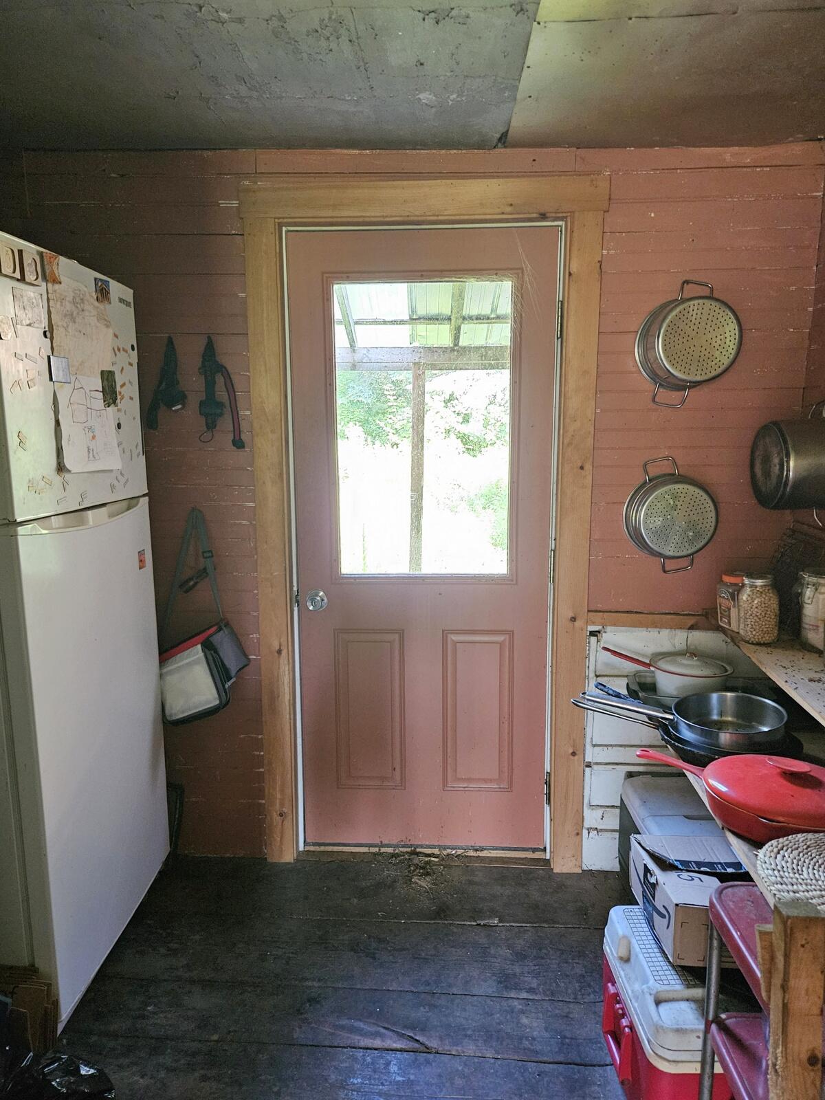Pantry with propane refrigerator at left. Door to back yard