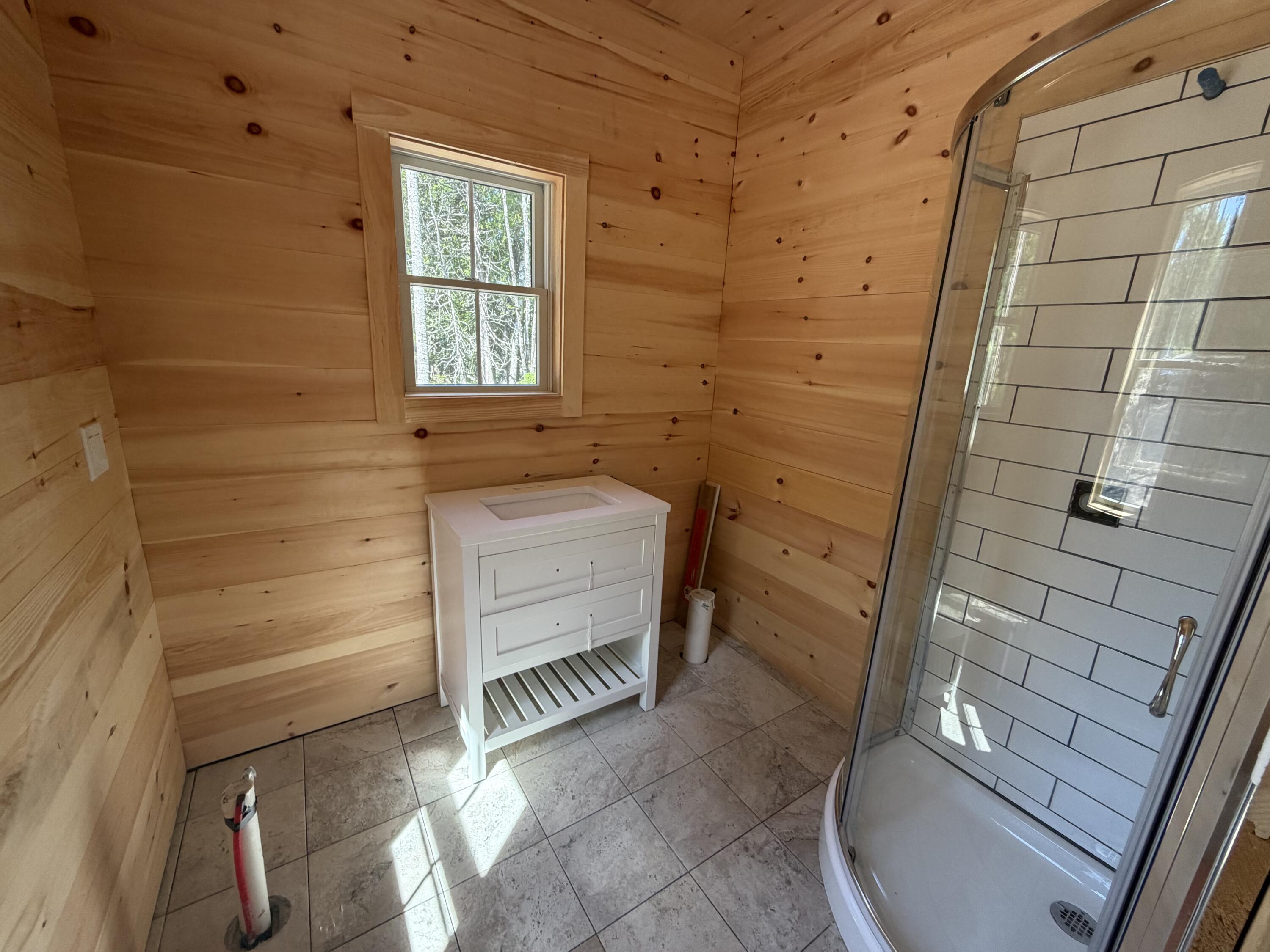 86 Back Shore Road, Steuben, ME 04680 Bathroom with shower and vanity in place.