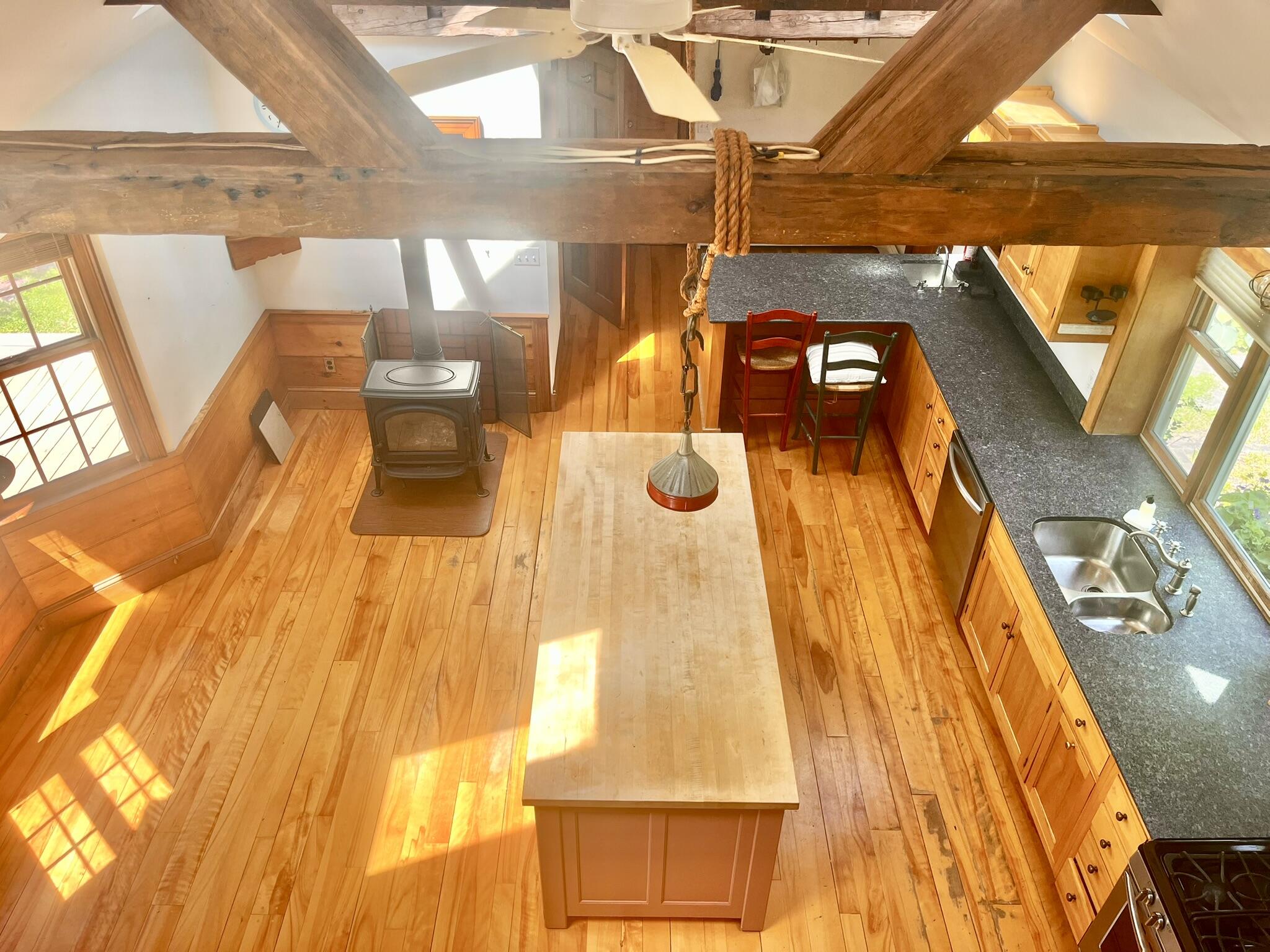 Chef's kitchen features plenty of granite counter space and a huge butcher block prep island.