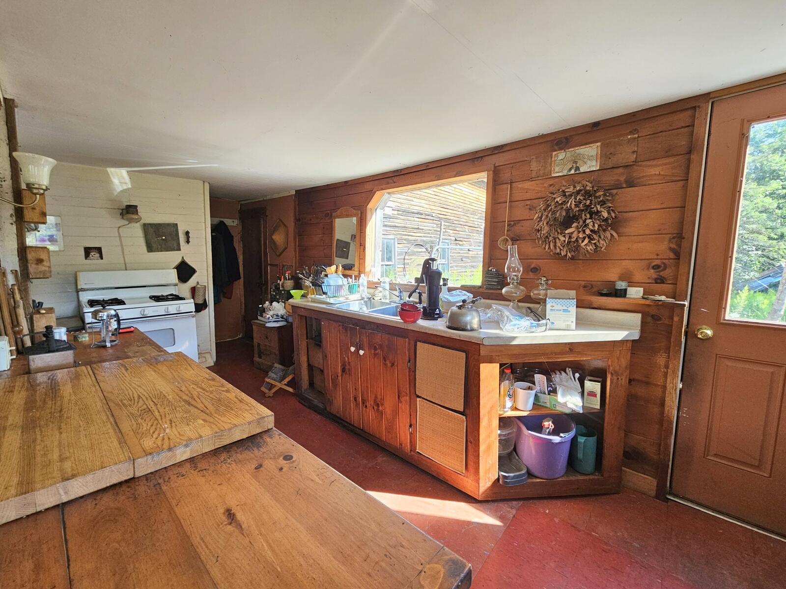 Hand pump beside sink is decorative at this point.Long counter at left for food prep or serving