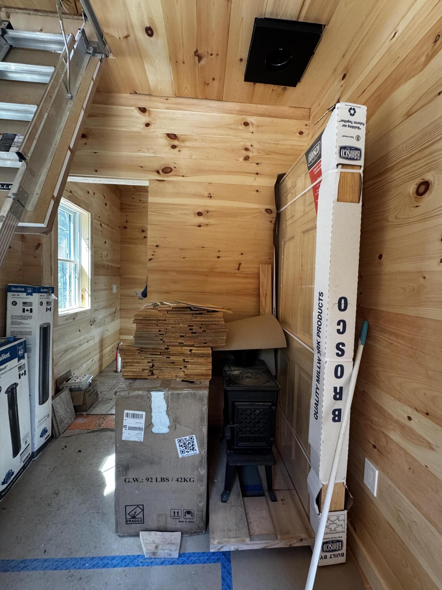 86 Back Shore Road, Steuben, ME 04680 Wood stove and stairs to loft in foyer area.