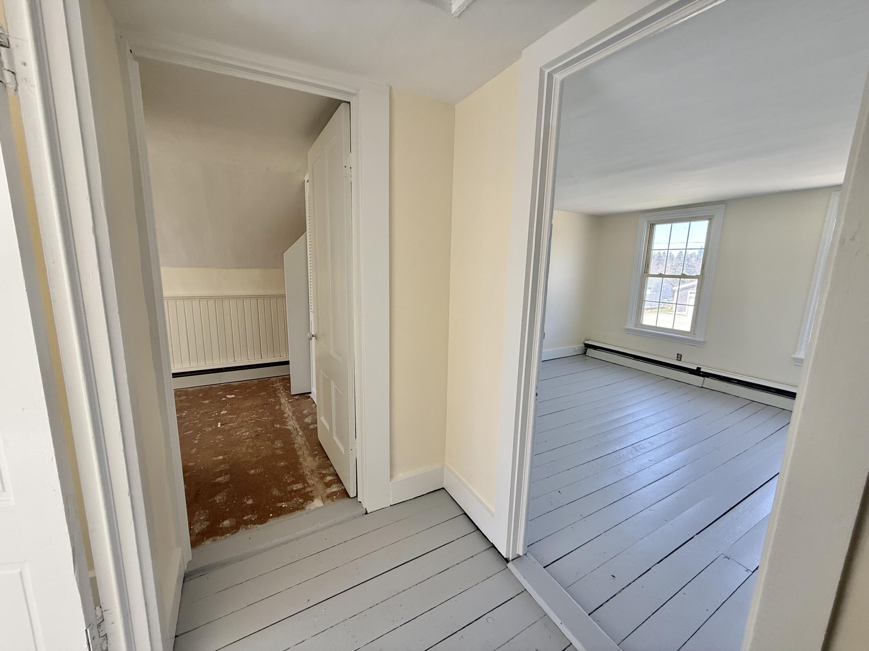 Looking into full bath and primary bedroom