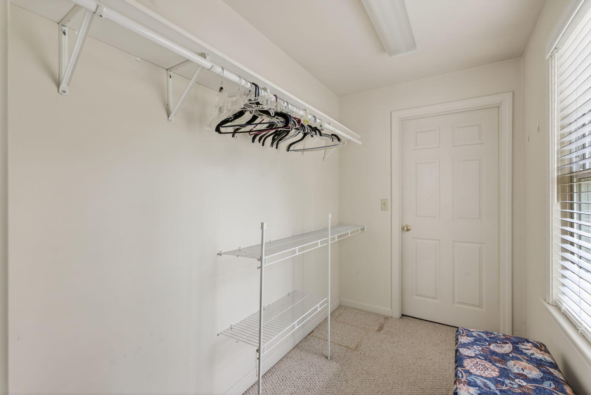 Primary bedroom with walk in closet and access to attic area
