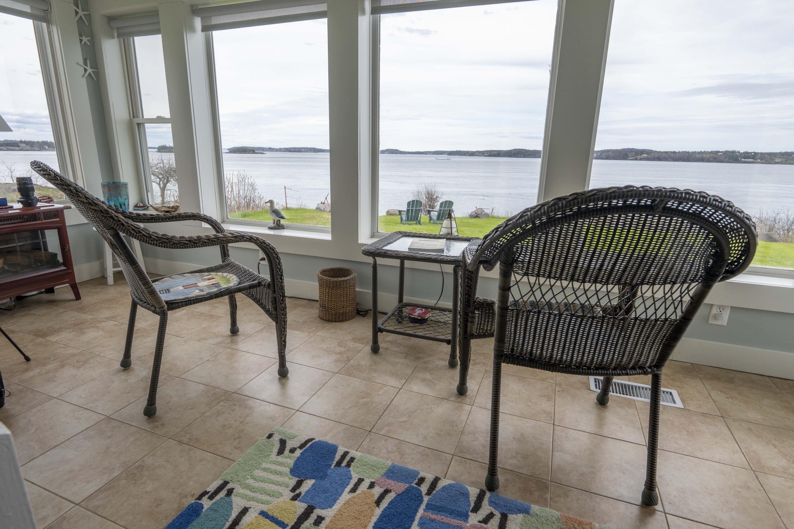 26 Madison Street, Eastport, ME 04631 Sunroom on cloudy day. Outside deck and entry door is to the right