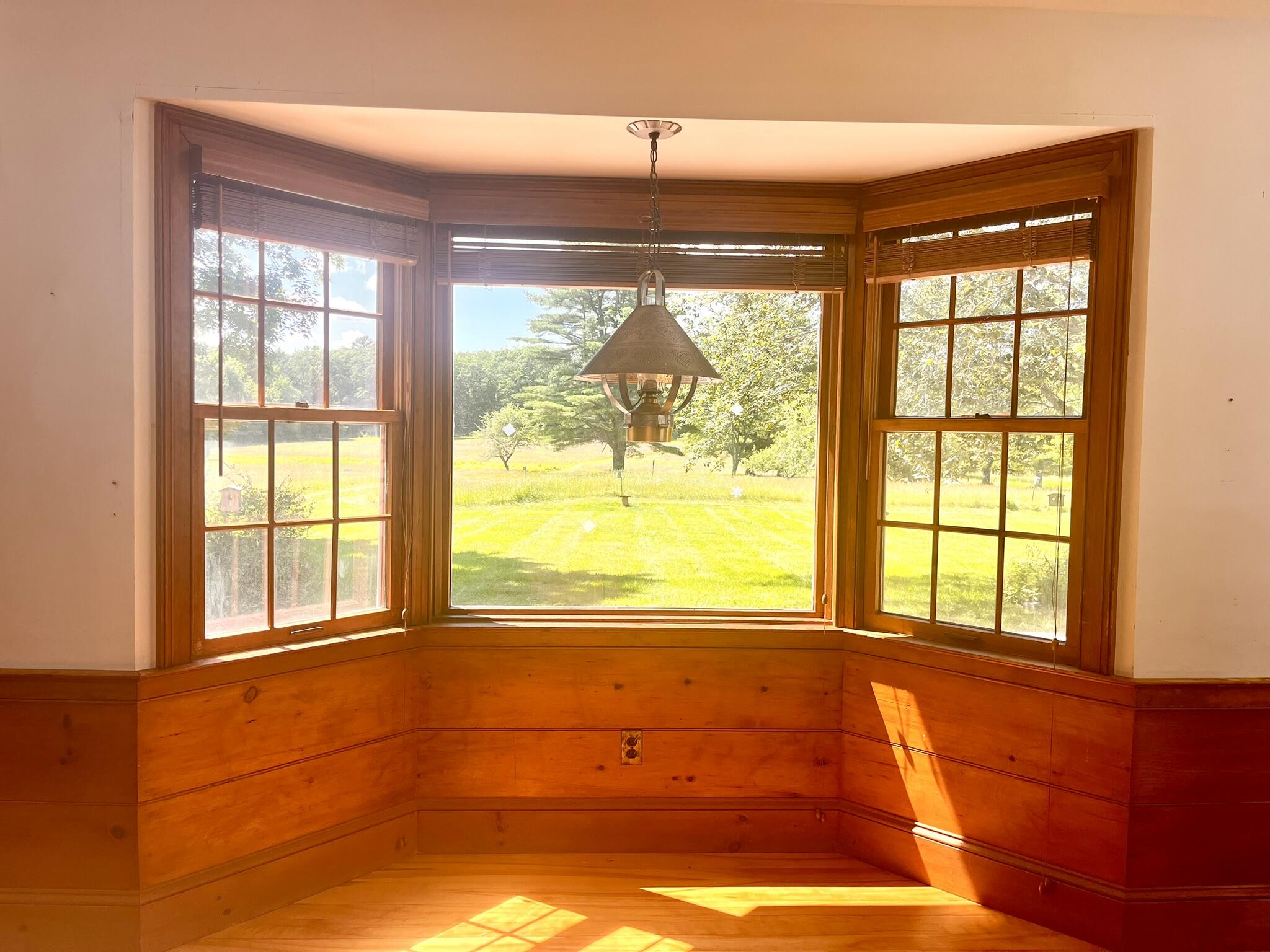 Breakfast nook overlooking the 15 acre field and woods beyond.