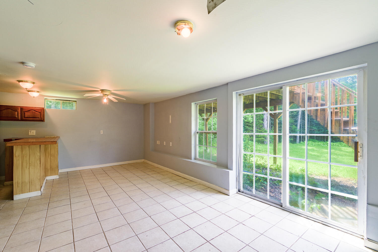 The downstairs fun room! Tile floor, slider to the backyard