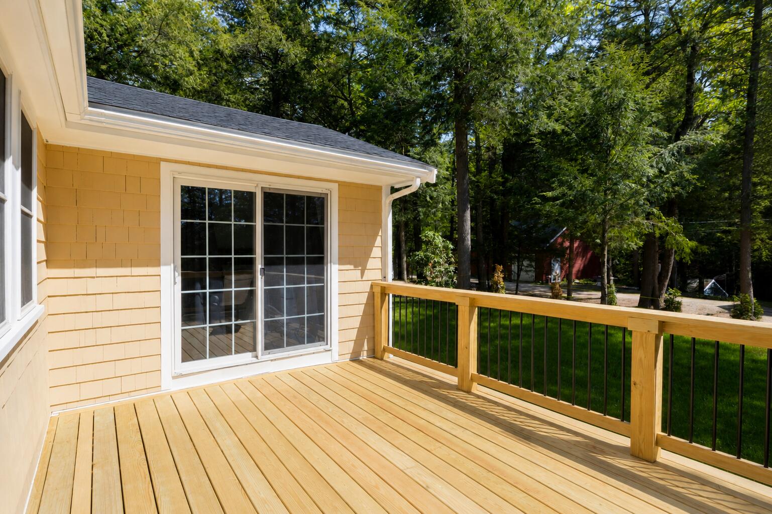 New deck off the primary bedroom that wraps around the back of the house