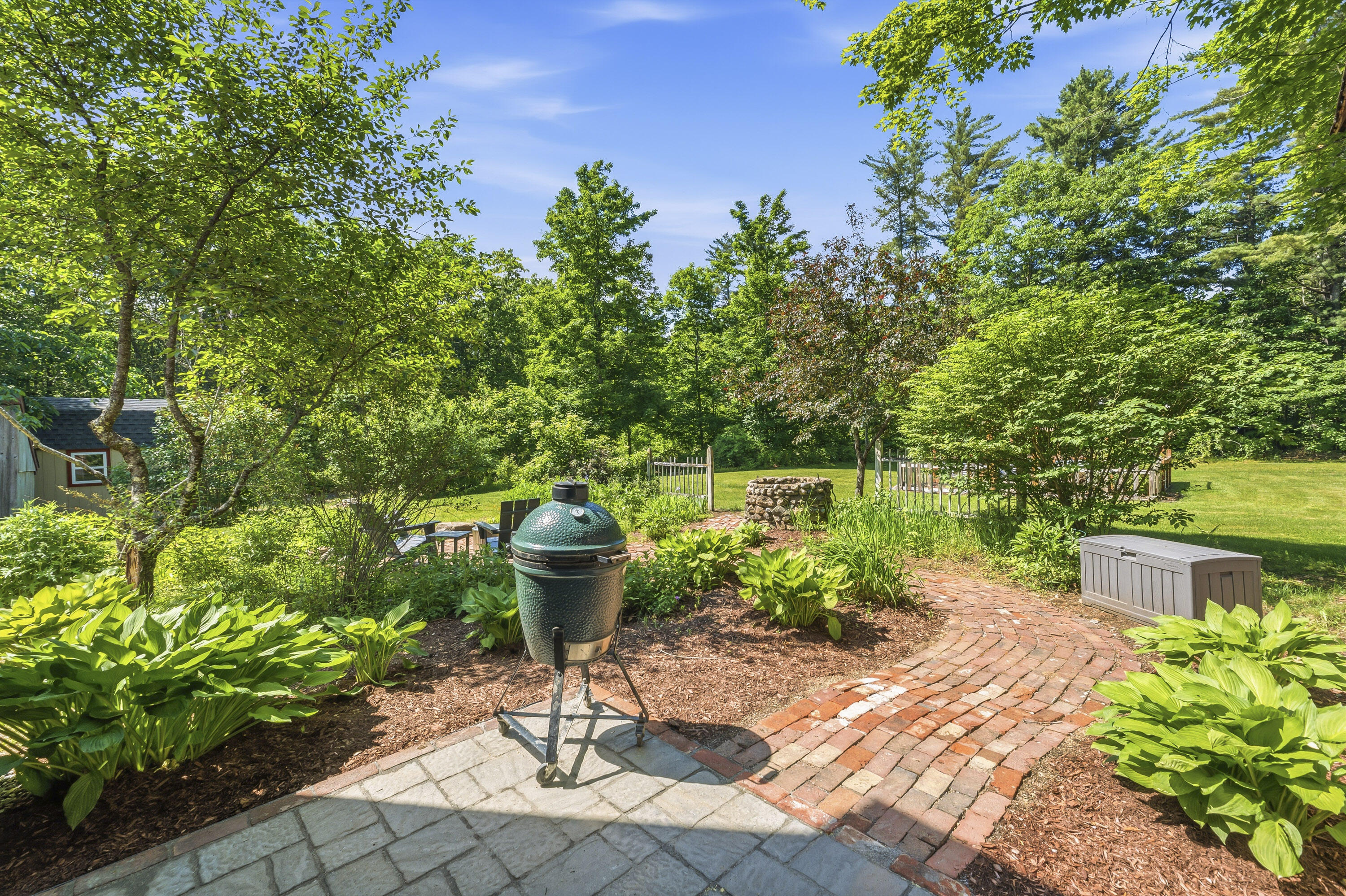 Inviting patio surrounded by mature perennial gardens