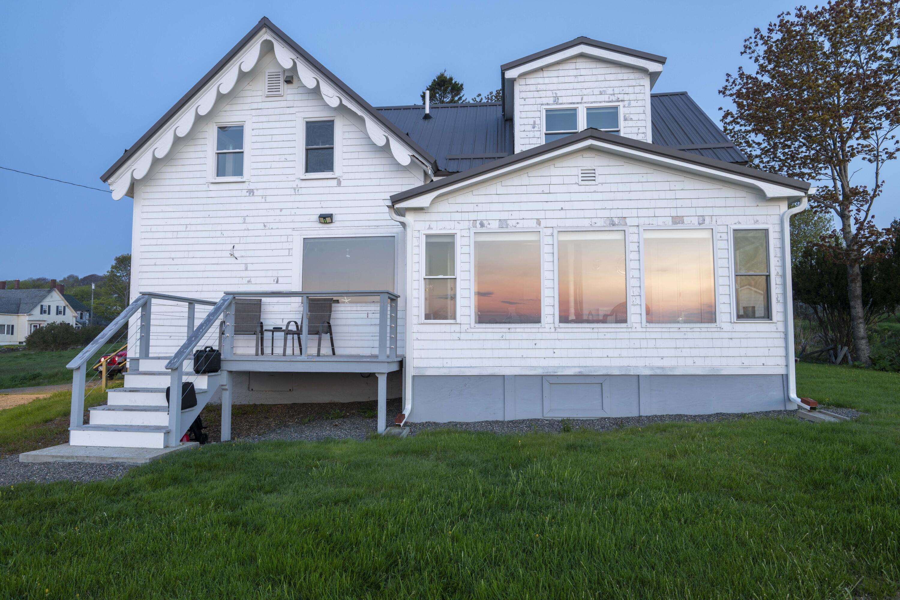 26 Madison Street, Eastport, ME 04631 Reflection of sunrise in sunroom windows