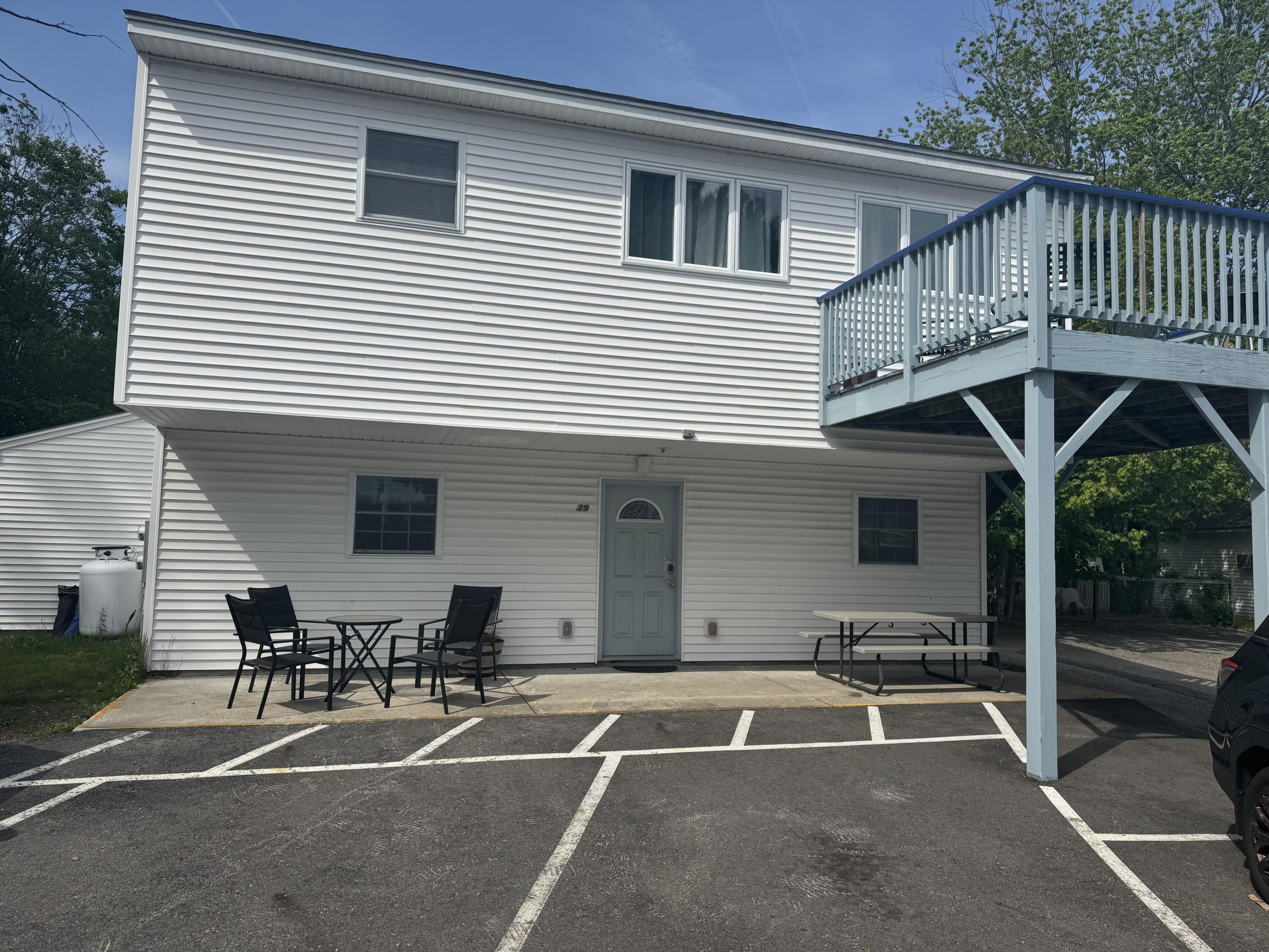 This two unit was converted into a condominium within a community of 12 condo units formerly part of the well-known Exit 5 Motel. This unique property offers an exceptional investment opportunity in a beautifully maintained seasonal resort setting. While the remaining 26 unit motel continues to operate seasonally, these condominium units are designated for year round use, making them ideal for weekly rentals throughout all seasons.  Situated on 3.2 acres of beautifully landscaped grounds, the property combines flexibility, comfort, and resort style amenities. This duplex style condominium features two separate living spaces. The first floor unit offers three bedrooms and one full bath, while the second-floor unit includes two bedrooms, one bath, and a spacious private deck perfect for relaxing or entertaining guests. Owners and guests enjoy full access to the property's extensive shared amenities, including a large seasonal indoor pool, a game room, an expansive outdoor deck area with a fire pit and ample seating, and a screened in gazebo ideal for gathering and unwinding. Families will also appreciate the large fenced playground area. Whether you are looking for an income-producing investment, a vacation retreat, or a versatile year-round property with strong rental potential, this condominium offers a rare opportunity in a desirable coastal setting. Convenient to local beaches. I-95 and 20 minutes to Portland.
