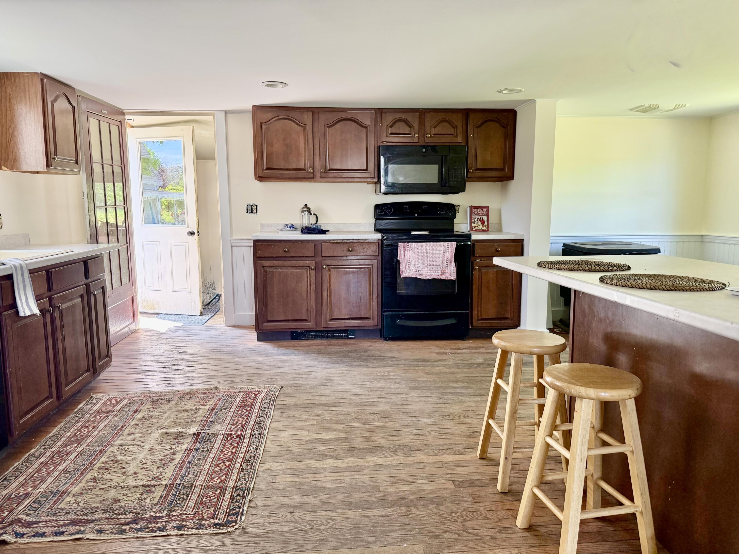 Spacious kitchen has a peninsula for dining, as well as an adjacent area for dining or seating.