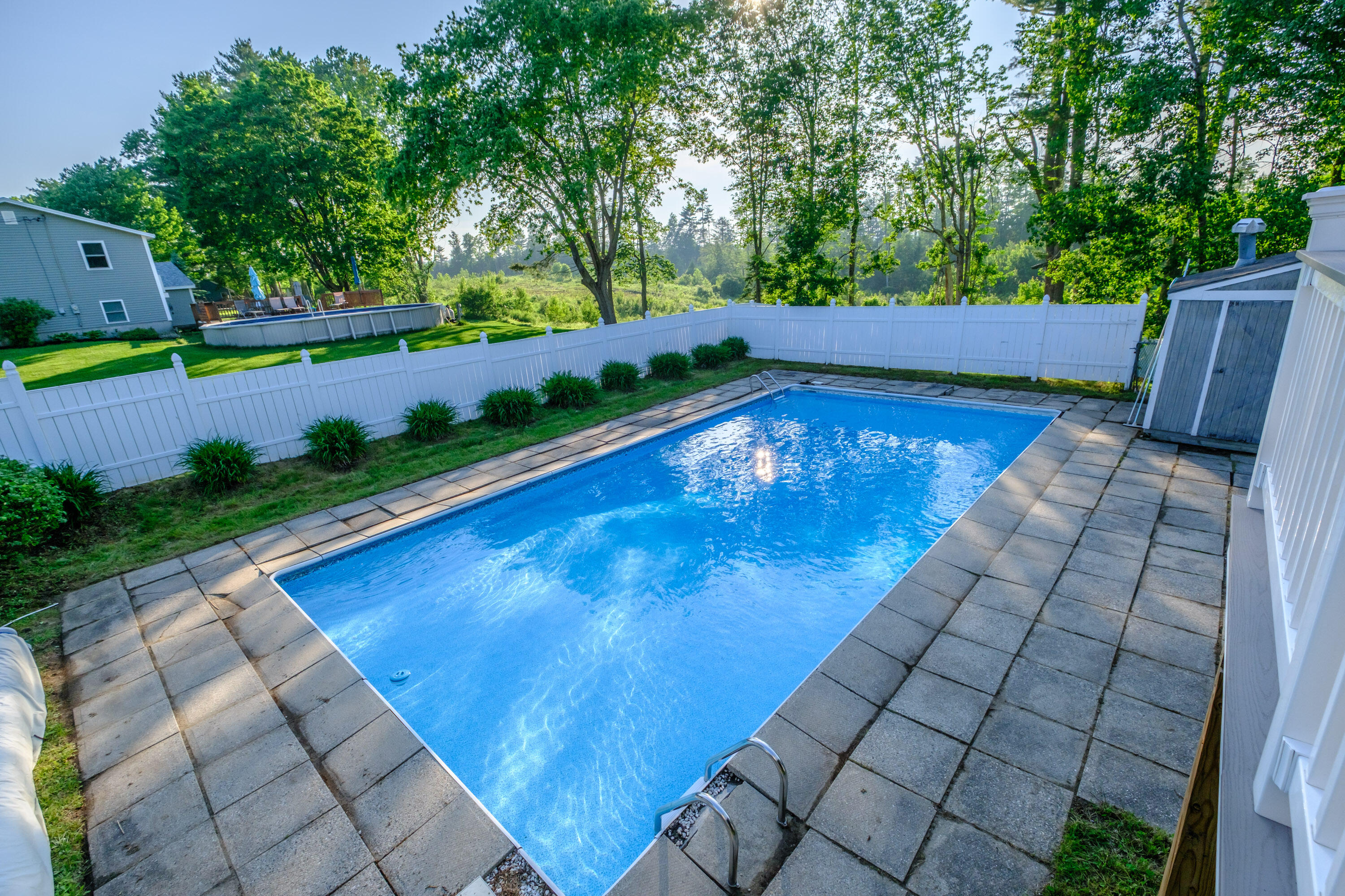 In-ground swimming pool with new sand filter and pool pump.