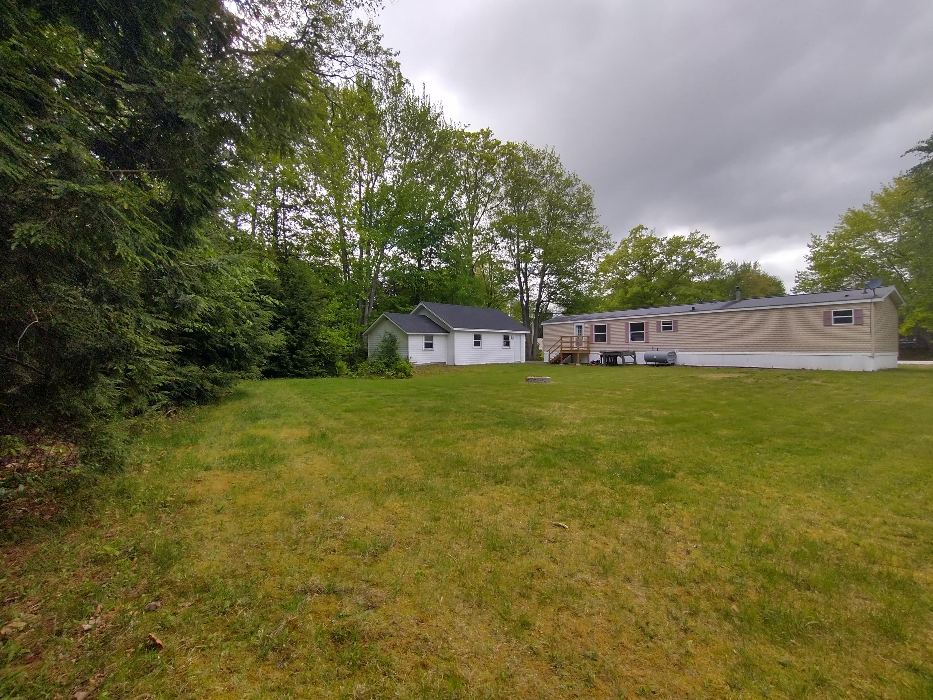 57 Carter Woods, Bradley, ME 04411 Spacious grassed back yard bordered by trees