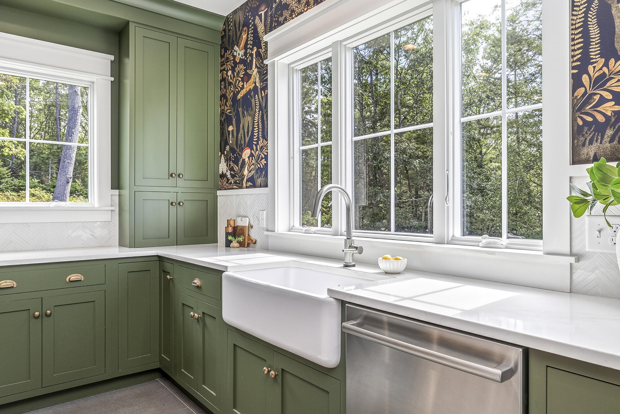 Quartz counters, herringbone pattern backsplash, and statement wallpaper