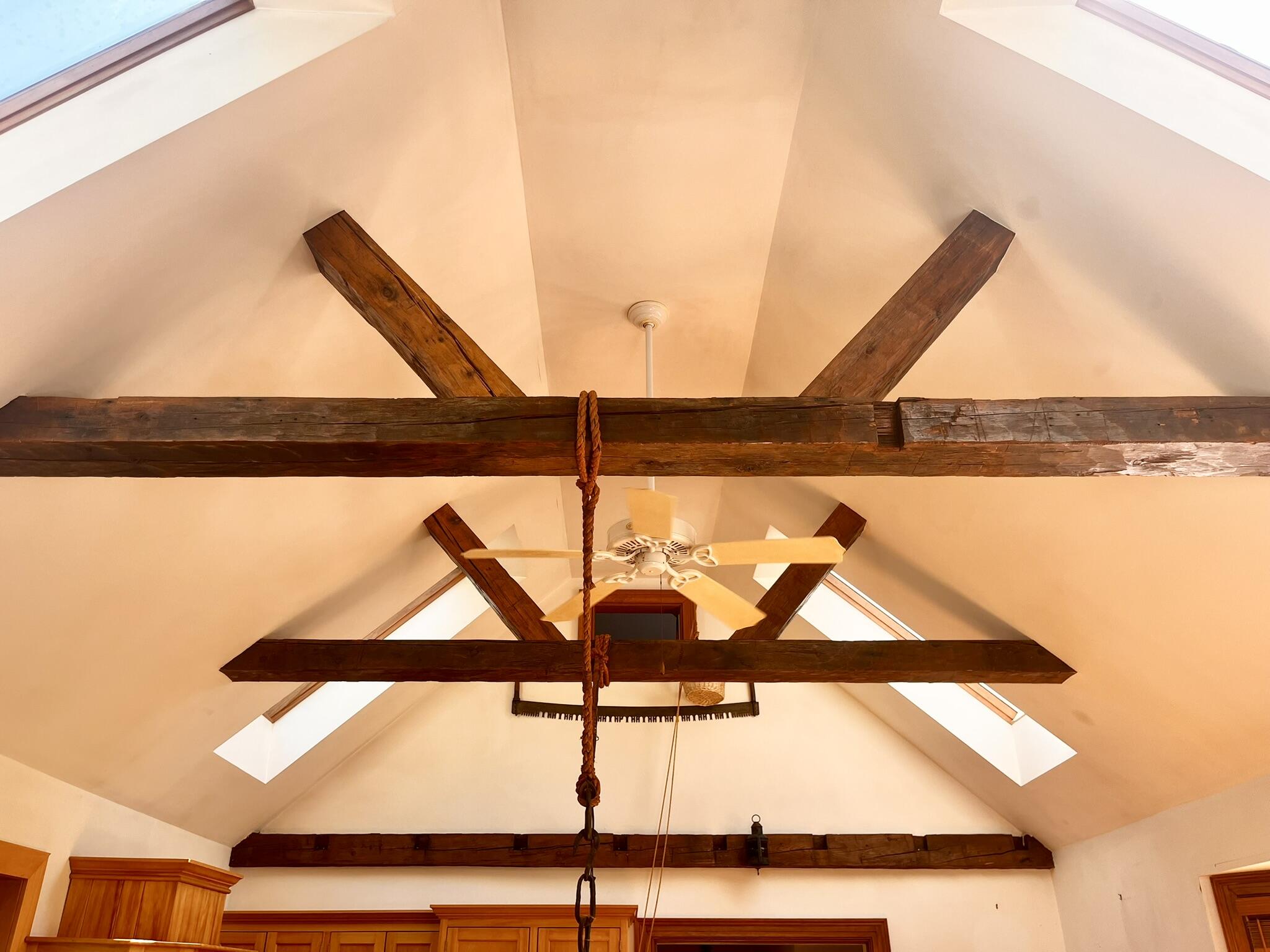 Cathedral ceiling in kitchen with exposed beams.