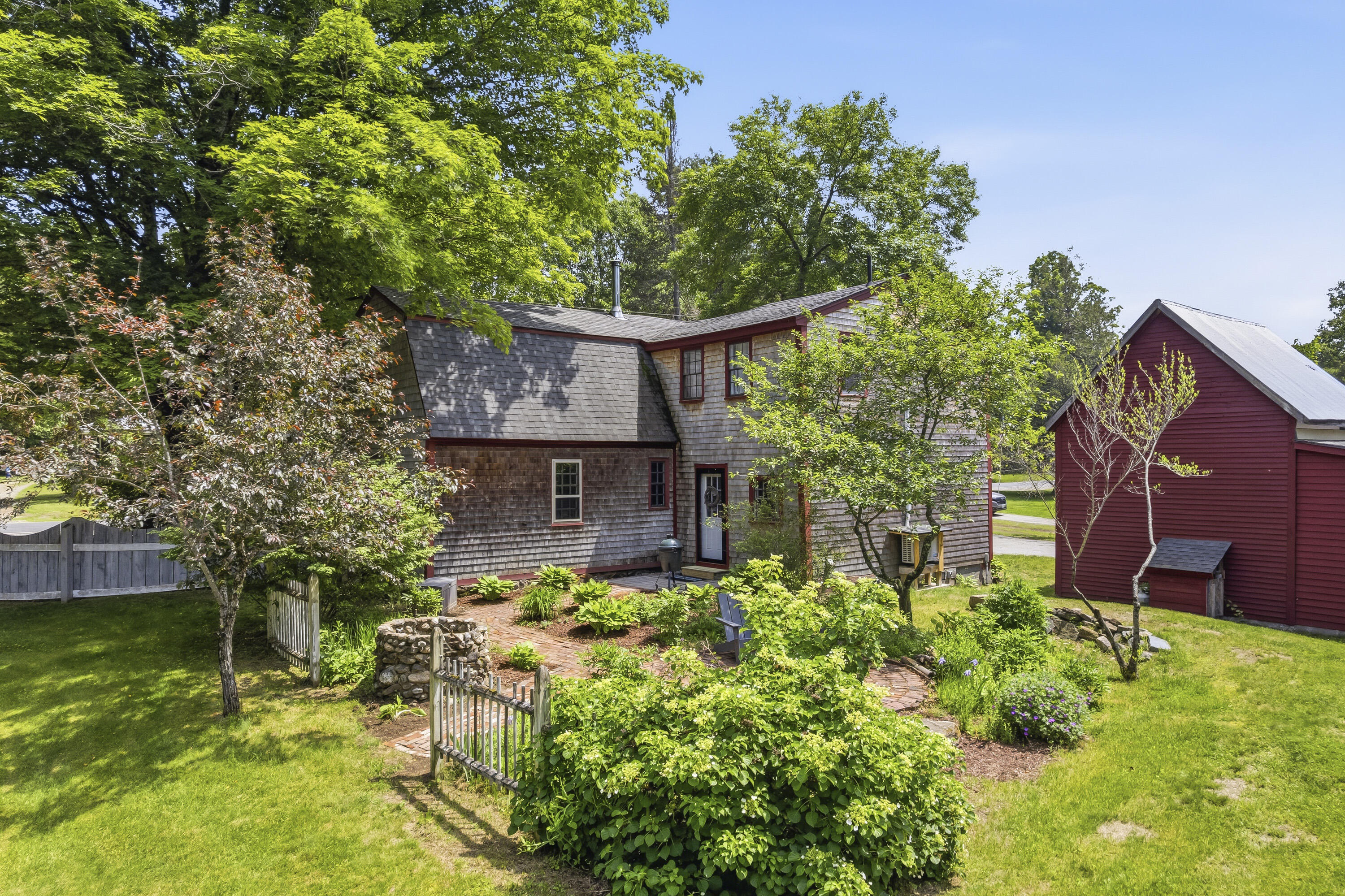 Inviting patio surrounded by mature perennial gardens