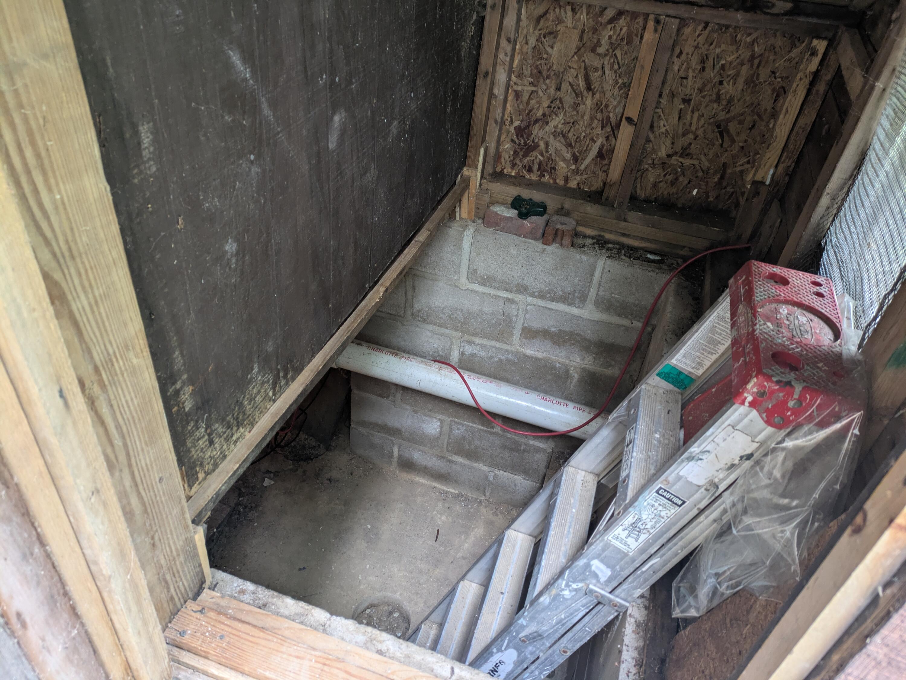 Entrance to crawl space behind house