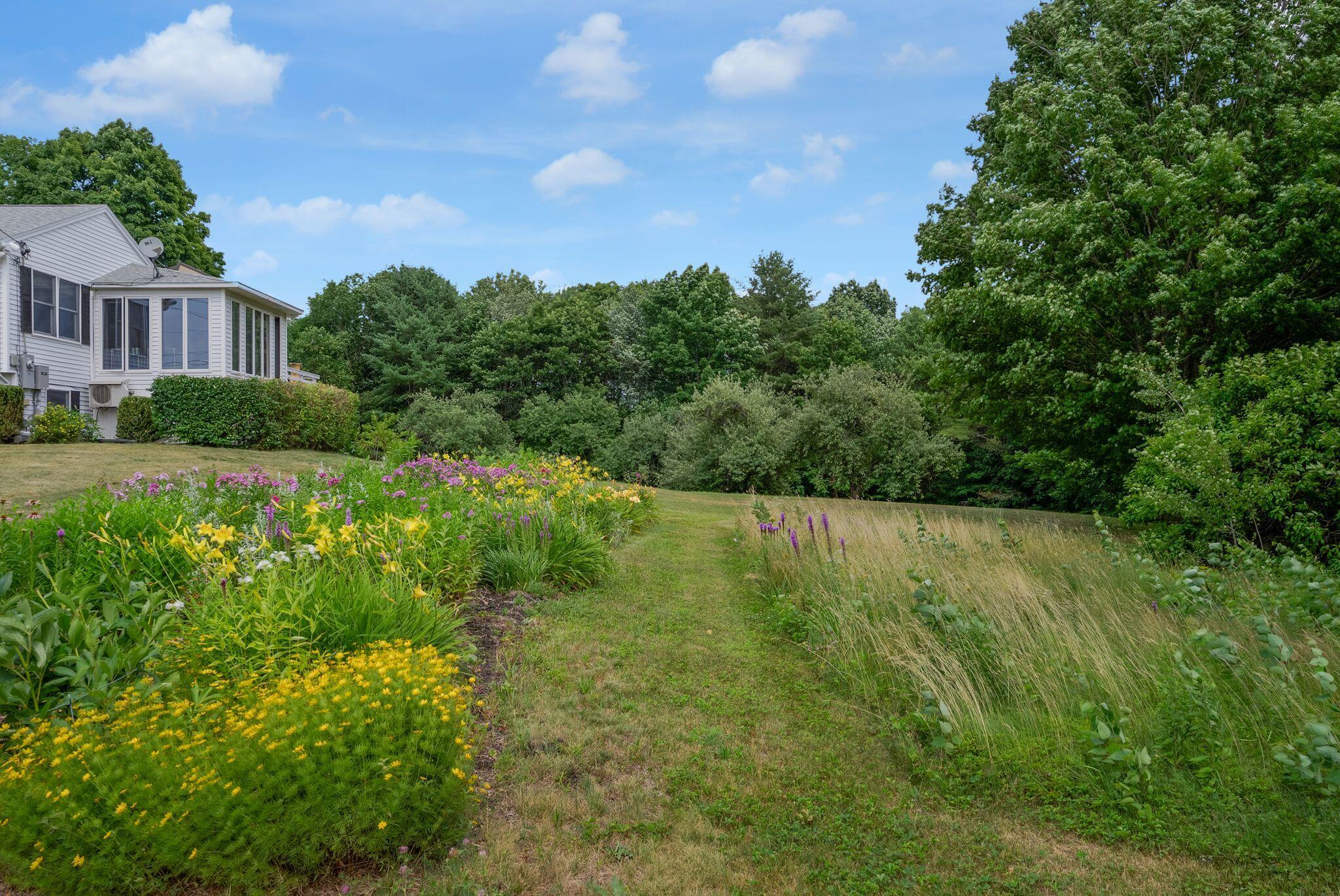 155 Ridge Road, Lisbon, ME 04252 The property features stunning perennial gardens and fruit trees!
