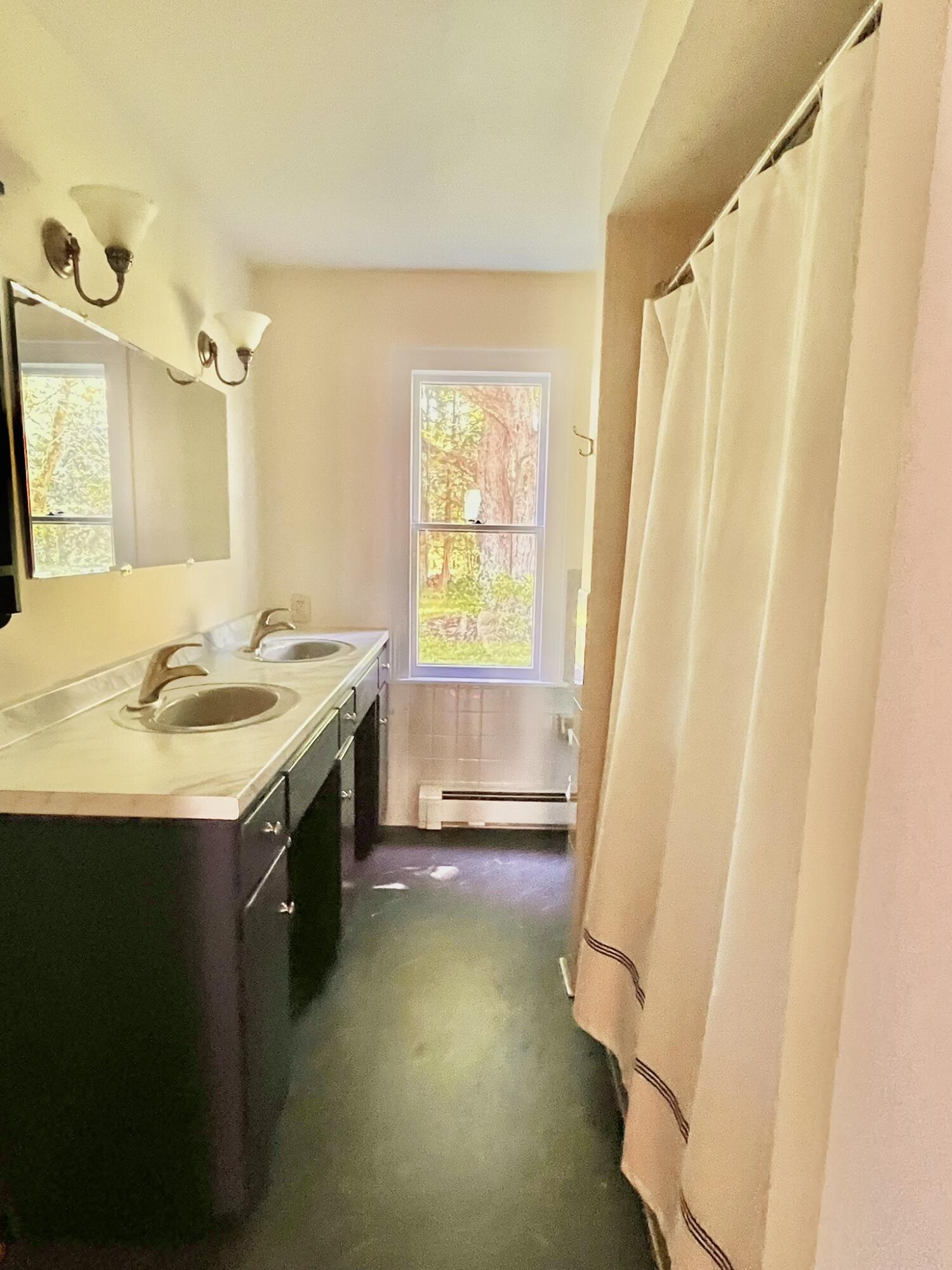 Main level bathroom, newly updated, adjacent to the primary bedroom.