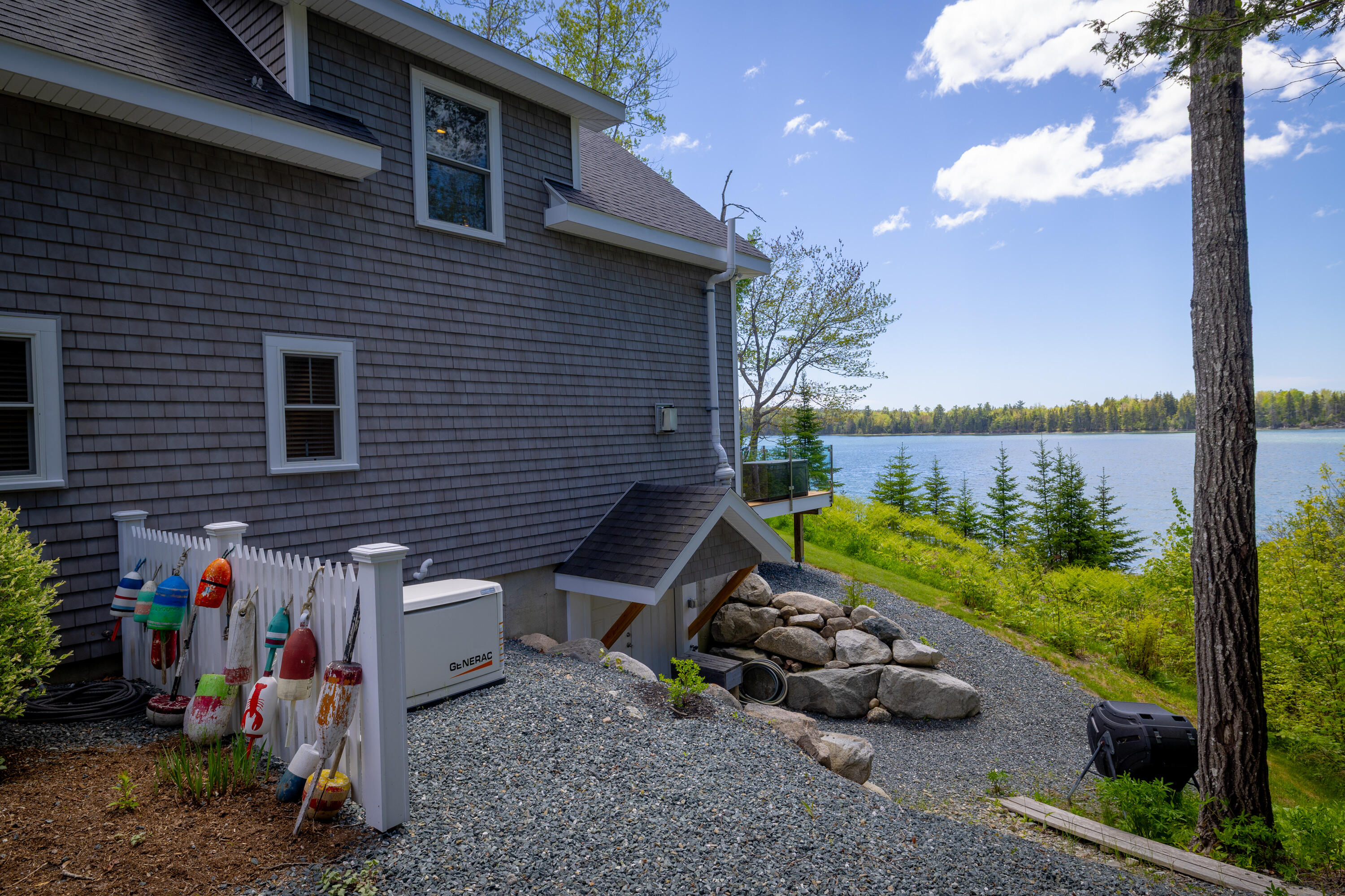 Right side of home. A/C and Generac and basement exterior double door entry