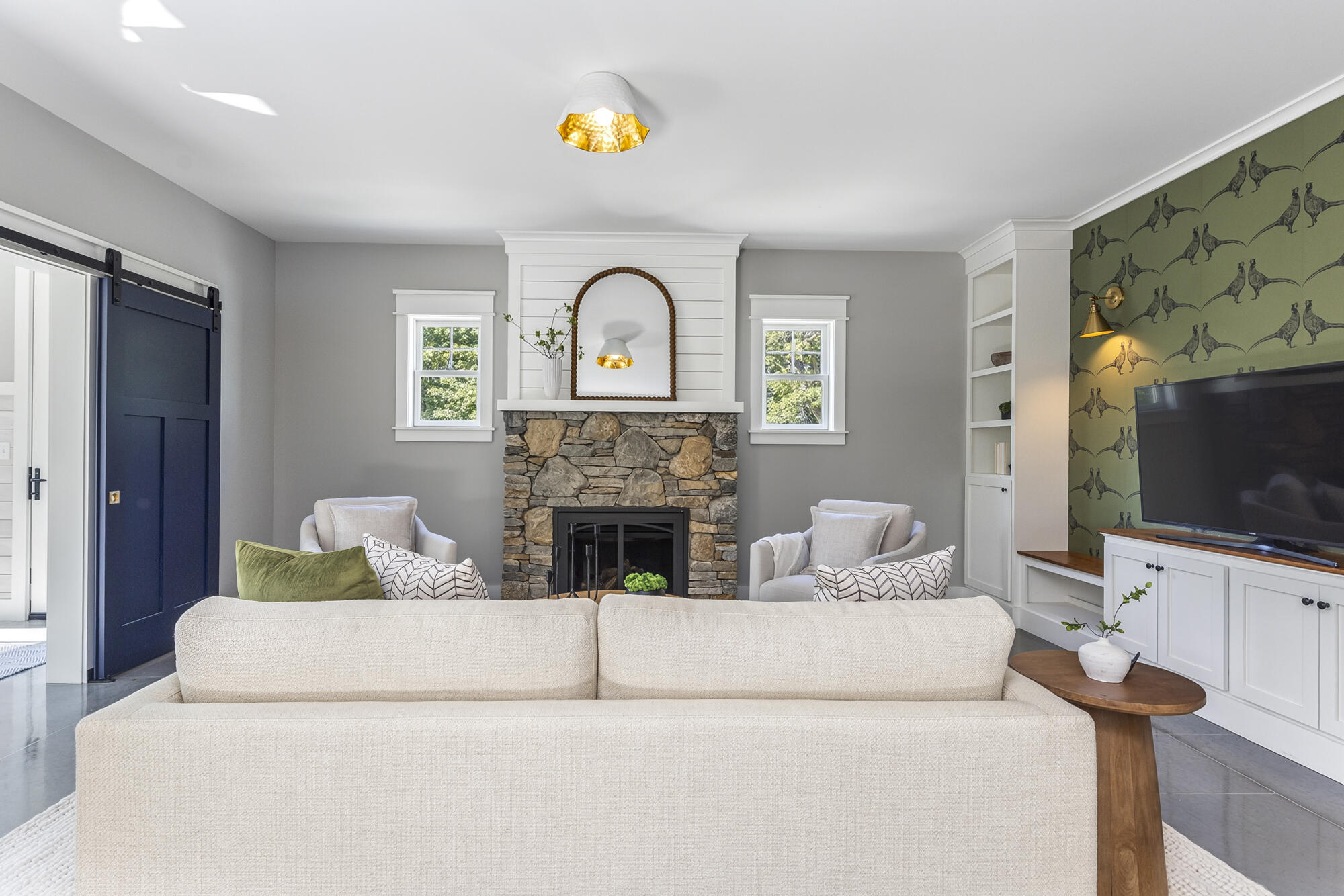 A gas fireplace with stone surround