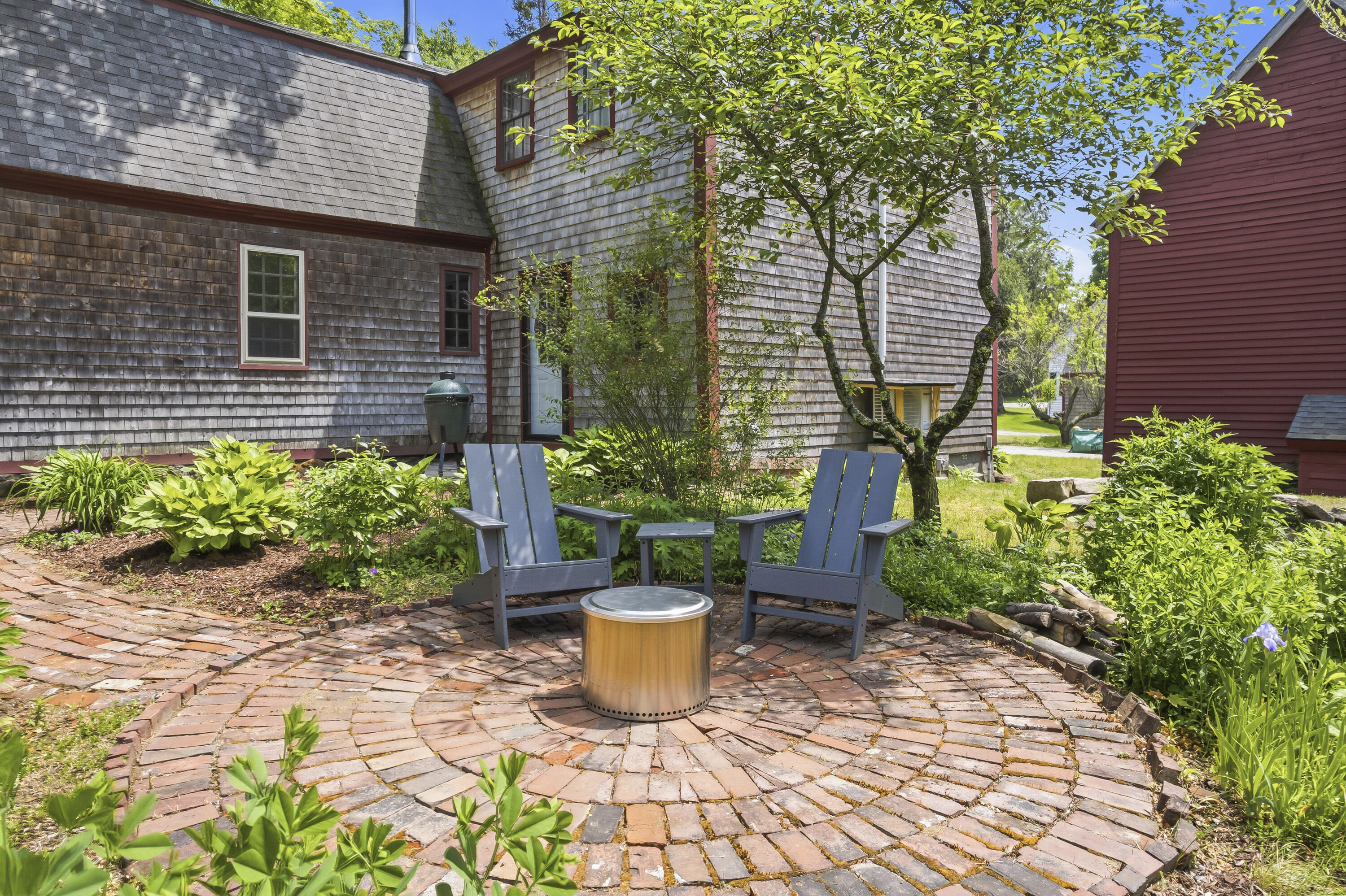 Inviting patio surrounded by mature perennial gardens
